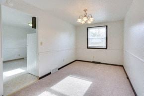 Amherst triplex for rent - an empty living room with a window and a ceiling fan