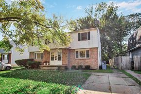 Amherst triplex for rent - A house with a white door and a brick wall.