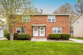 Amherst triplex for rent - the front of a brick house with a white front door