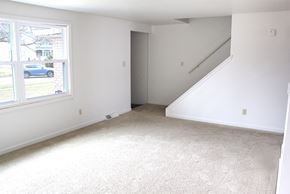 Amherst triplex for rent - an empty room with a large window and white walls