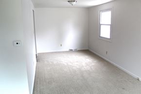 Amherst triplex for rent - an empty room with white walls and a window