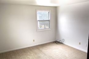 Amherst triplex for rent - an empty room with white walls and a window
