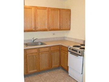 Buffalo apartment for rent - A kitchen with wooden cabinets and a white oven.