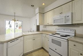 East Amherst house for rent - A white kitchen with a stove, sink, and cabinets.
