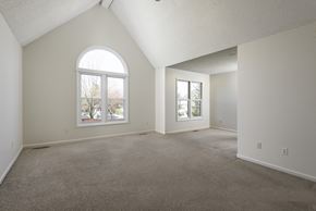 East Amherst house for rent - A spacious room with a large window and carpeted floor.