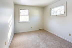 Amherst house for rent - A white room with two windows.