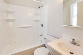 Amherst house for rent - A white bathroom with a toilet, sink, and bathtub.