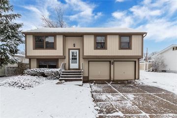 Amherst triplex for rent - a tan house with a garage in the snow