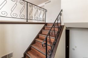 Amherst triplex for rent - stairs in a home with a railing and a white wall