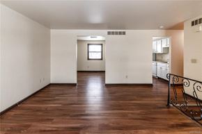 Amherst triplex for rent - an empty living room with wood floors and a staircase