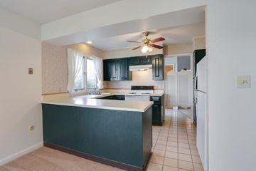 East Amherst condo for rent - A kitchen with a black counter and a fan.