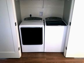 Duxbury apartment for rent - two washers and dryers in a room with a door
