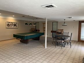 Canton townhouse for rent - a game room with a pool table and a dining table