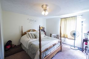 Canton apartment for rent - a bedroom with a bed and a fan