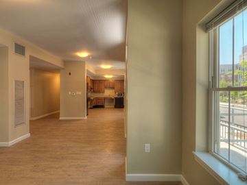 South Boston apartment for rent - an empty living room and kitchen with large windows