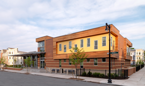 South Boston apartment for rent - the building has a red brick facade and a yellow building with windows
