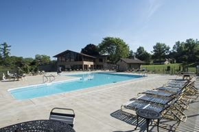 Canton apartment for rent - a swimming pool with lounge chairs next to a building
