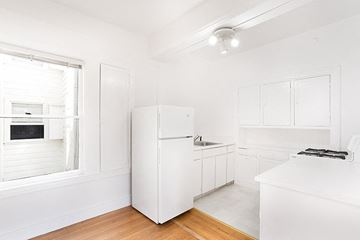 San Francisco apartment for rent - a white kitchen with a refrigerator and a window