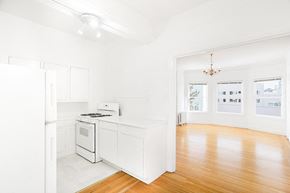San Francisco apartment for rent - an empty kitchen with a stove and a refrigerator