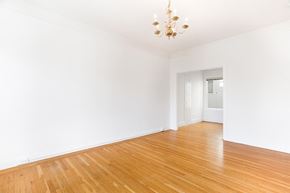 San Francisco apartment for rent - a empty living room with a wooden floor and a chandelier