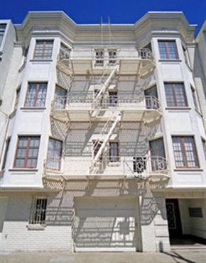 San Francisco apartment for rent - a white building with a fire escape on the side of it