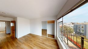 San Francisco apartment for rent - a living room with a large window and a balcony