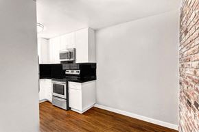 San Francisco apartment for rent - an empty kitchen with a stove and a microwave