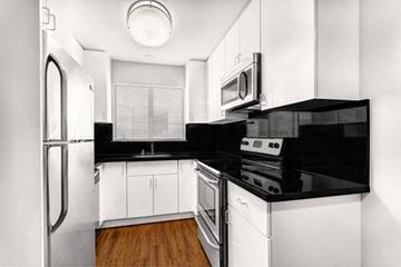 San Francisco apartment for rent - a black and white kitchen with a stove and refrigerator