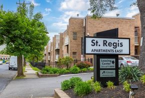 Philadelphia apartment for rent - A sign for St. Regis Apartments East is in front of a brick building.