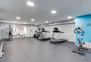Philadelphia apartment for rent - A gym with a variety of equipment including treadmills, weights, and exercise bikes.