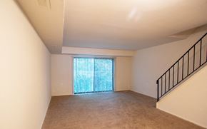 Lindenwold apartment for rent - A room with a carpeted floor and a staircase with a railing.