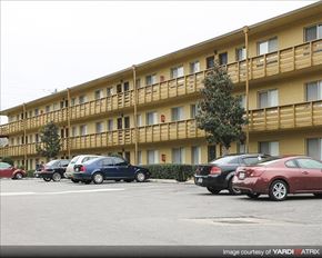 Tallahassee apartment for rent - a parking lot with cars parked in front of an apartment building