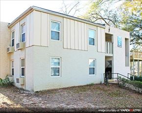 Tallahassee apartment for rent - a white house with a yard in front of it