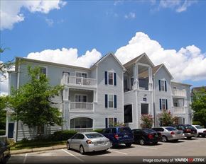 Gainesville apartment for rent - an apartment building with cars parked in front of it