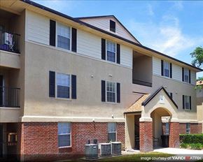 Gainesville apartment for rent - a large apartment building with brick and white walls