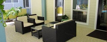 Gainesville apartment for rent - a patio with chairs and a glass table