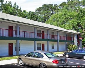 Gainesville townhouse for rent - a building with cars parked in front of it