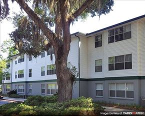 Gainesville townhouse for rent - a apartment building with a tree in front of it