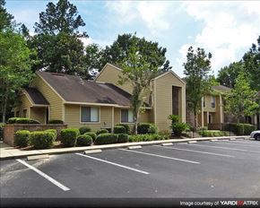 Gainesville apartment for rent - an empty parking lot in front of an apartment building