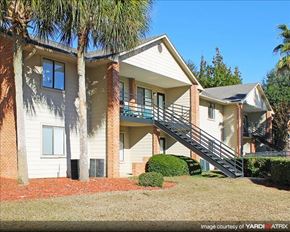 Tallahassee apartment for rent - a white house with a staircase and a palm tree
