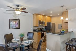 Los Angeles apartment for rent - an open kitchen and dining area with a glass table and chairs