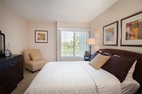 Los Angeles apartment for rent - a bedroom with a bed and a chair and a window