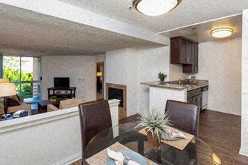 Hollywood apartment for rent - a living room and dining room with a glass table