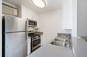 Hollywood apartment for rent - a kitchen with stainless steel appliances and a sink
