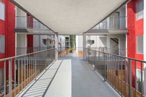 Los Feliz apartment for rent - a corridor with metal fences and balconies in a building