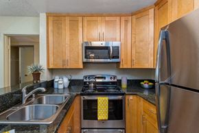 Los Feliz apartment for rent - a kitchen with stainless steel appliances and wooden cabinets