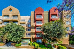 Los Angeles apartment for rent - a large apartment building with trees in front of it