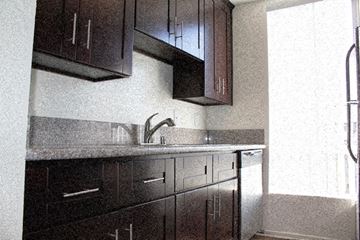 Los Angeles apartment for rent - A kitchen with dark brown cabinets and a granite counter.