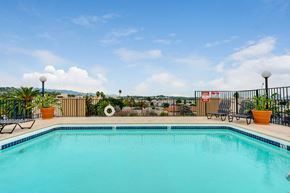 Los Angeles apartment for rent - A swimming pool with a red and white sign on the fence.