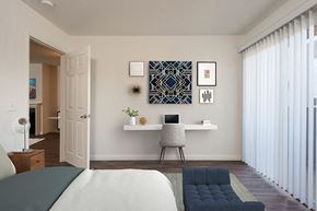 Los Angeles apartment for rent - a bedroom with a bed and a desk with a laptop